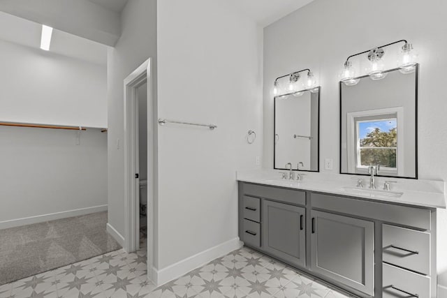 7804 Alouette Dr, Austin, TX 78738 - bathroom with tile patterned floors, double vanity, baseboards, a spacious closet, and toilet