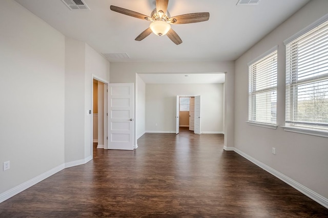 8017 Turnberry Ln, Austin, TX 78744 - unfurnished room with dark wood finished floors, a ceiling fan, and baseboards