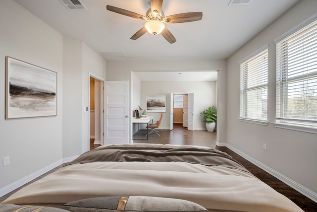 8017 Turnberry Ln, Austin, TX 78744 - bedroom featuring dark wood-style floors, baseboards, an office area, and a ceiling fan