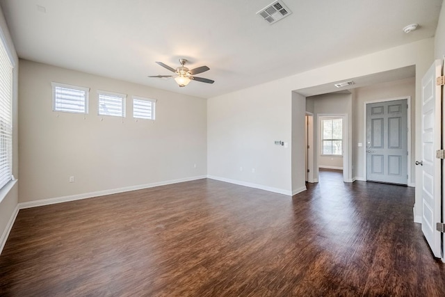 8017 Turnberry Ln, Austin, TX 78744 - unfurnished room with a ceiling fan, healthy amount of natural light, dark wood finished floors, and baseboards