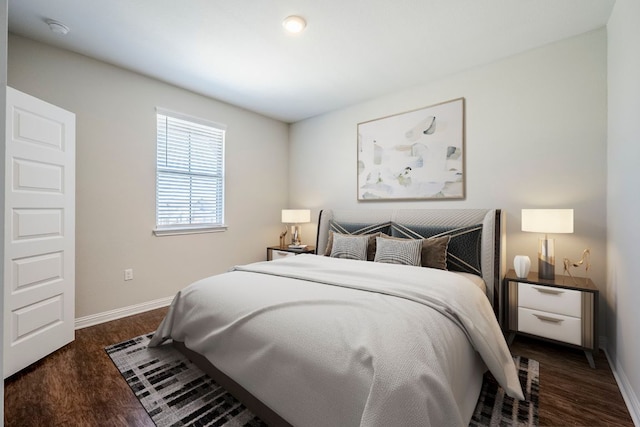 8017 Turnberry Ln, Austin, TX 78744 - bedroom featuring baseboards and dark wood-style floors