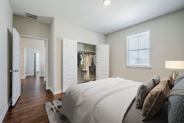 8017 Turnberry Ln, Austin, TX 78744 - bedroom with dark wood-type flooring, baseboards, and a closet