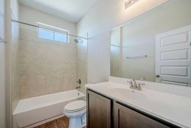 8017 Turnberry Ln, Austin, TX 78744 - bathroom with toilet, vanity, wood finished floors, and shower / bathtub combination