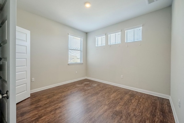 8017 Turnberry Ln, Austin, TX 78744 - empty room featuring dark wood finished floors and baseboards