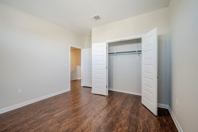 8017 Turnberry Ln, Austin, TX 78744 - unfurnished bedroom featuring wood finished floors, baseboards, and a closet