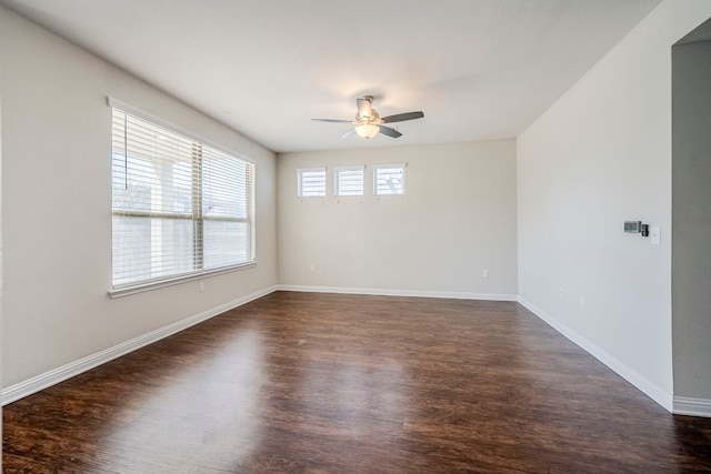 8017 Turnberry Ln, Austin, TX 78744 - empty room with a ceiling fan, dark wood-style flooring, and baseboards