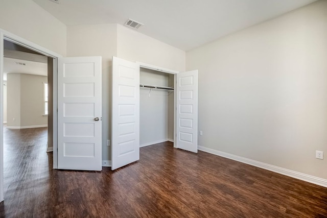 8017 Turnberry Ln, Austin, TX 78744 - unfurnished bedroom featuring dark wood finished floors, baseboards, and a closet