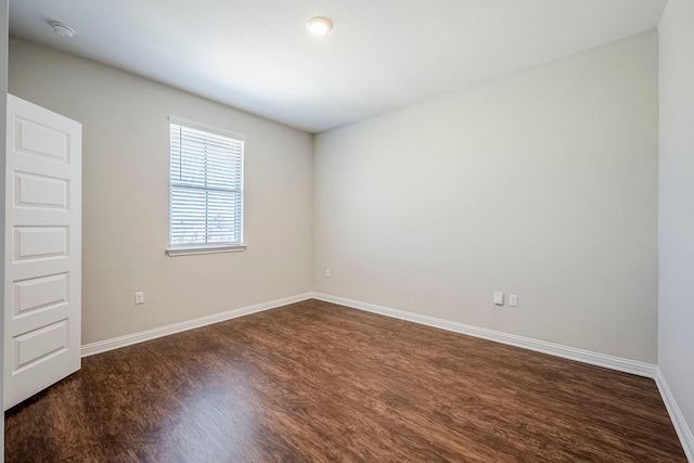 8017 Turnberry Ln, Austin, TX 78744 - unfurnished room with dark wood-style floors, baseboards, and a smoke detector