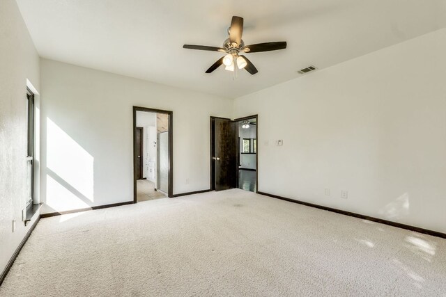 30809 Berry Creek Dr, Georgetown, TX 78628 - empty room featuring light carpet, ceiling fan, and baseboards