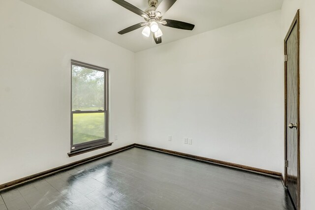 30809 Berry Creek Dr, Georgetown, TX 78628 - empty room featuring a ceiling fan, wood finished floors, and baseboards
