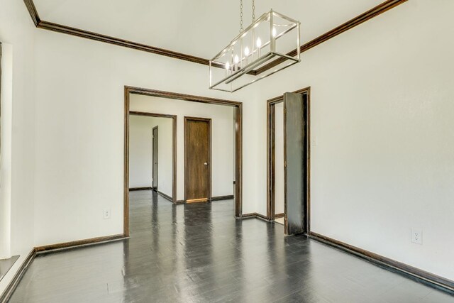30809 Berry Creek Dr, Georgetown, TX 78628 - empty room with a chandelier, crown molding, dark wood finished floors, and baseboards