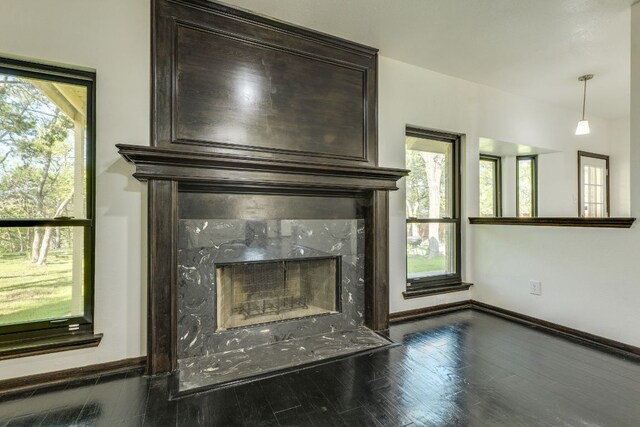 30809 Berry Creek Dr, Georgetown, TX 78628 - detailed view of a fireplace, baseboards, and wood finished floors