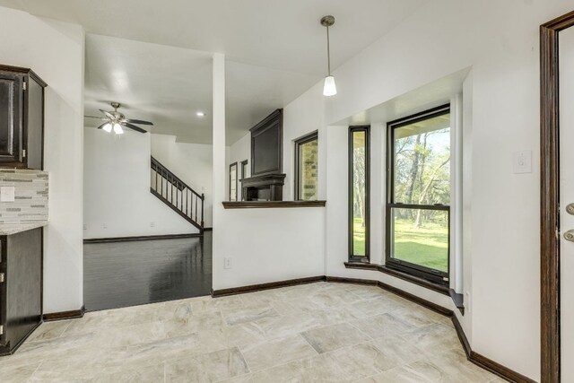 30809 Berry Creek Dr, Georgetown, TX 78628 - unfurnished living room featuring a ceiling fan, baseboards, and stairway