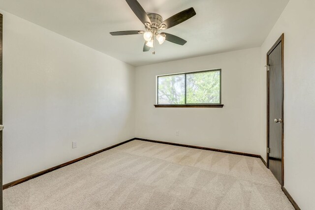 30809 Berry Creek Dr, Georgetown, TX 78628 - unfurnished room featuring light carpet, ceiling fan, and baseboards
