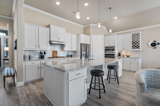 5352 Cornetto Blfs, Round Rock, TX 78665 - kitchen featuring stainless steel appliances, backsplash, crown molding, white cabinetry, and recessed lighting