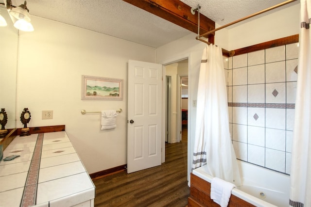 1683 Kuehler Ave, New Braunfels, TX 78130 - full bathroom featuring shower / bath combo, a textured ceiling, and wood finished floors