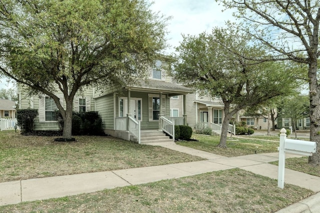 1225 Cardigan St, Cedar Park, TX 78613 - view of property hidden behind natural elements featuring covered porch and a front lawn