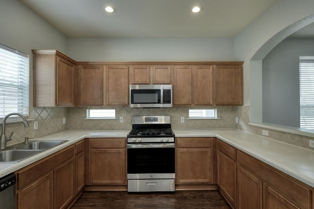 1225 Cardigan St, Cedar Park, TX 78613 - kitchen with stainless steel appliances, dark wood-type flooring, arched walkways, backsplash, and recessed lighting