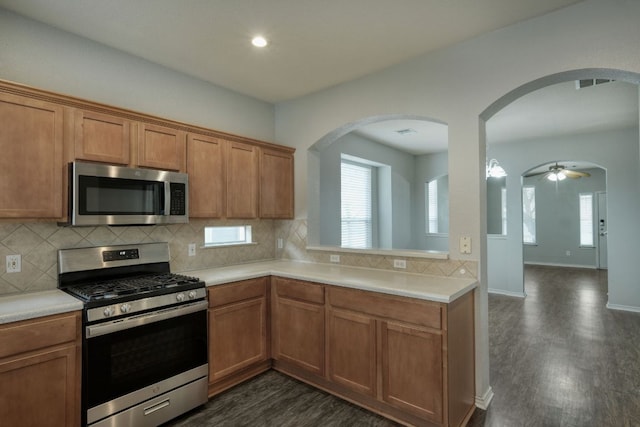 1225 Cardigan St, Cedar Park, TX 78613 - kitchen with appliances with stainless steel finishes, dark wood-type flooring, light countertops, backsplash, and recessed lighting