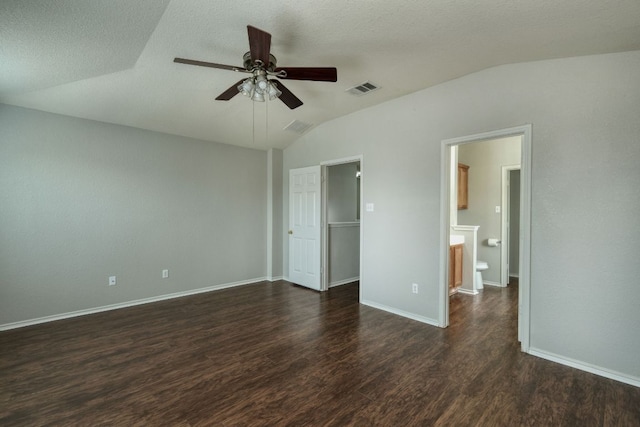 1225 Cardigan St, Cedar Park, TX 78613 - unfurnished bedroom featuring vaulted ceiling, dark wood-style floors, a walk in closet, baseboards, and a ceiling fan