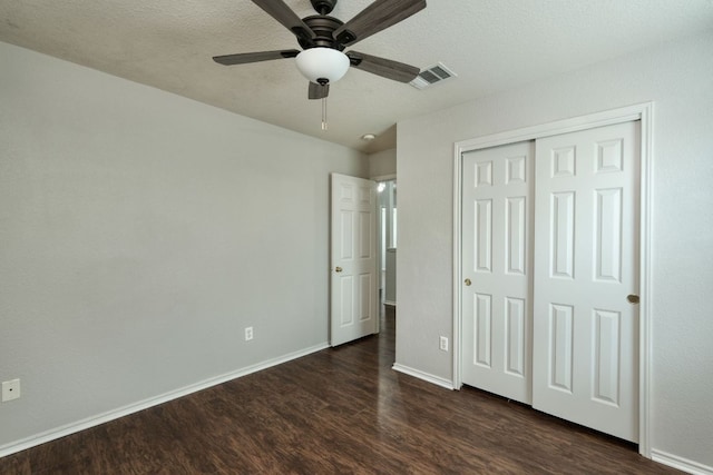 1225 Cardigan St, Cedar Park, TX 78613 - unfurnished bedroom with dark wood-type flooring, baseboards, a closet, ceiling fan, and a textured ceiling