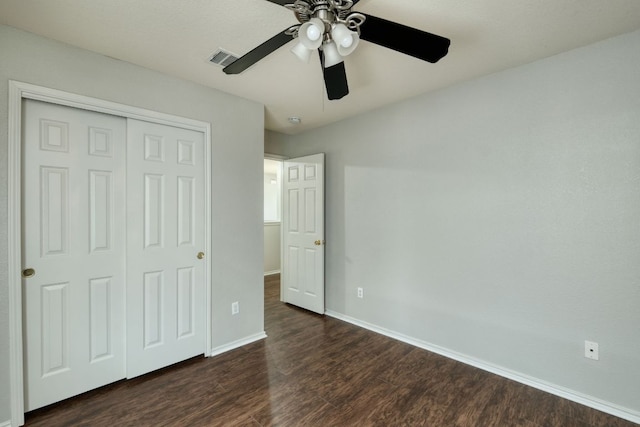 1225 Cardigan St, Cedar Park, TX 78613 - unfurnished bedroom with dark wood finished floors, a closet, and a ceiling fan