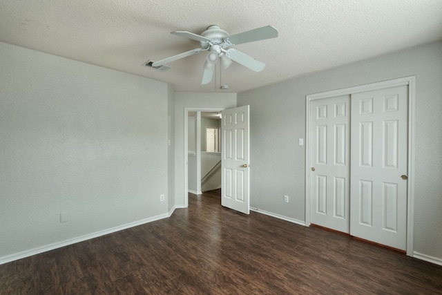 1225 Cardigan St, Cedar Park, TX 78613 - unfurnished bedroom with dark wood-type flooring, baseboards, a closet, a ceiling fan, and a textured ceiling