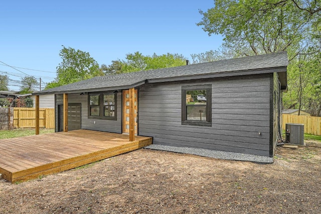 1601 N Redondo Dr, Austin, TX 78721 - rear view of property with central air condition unit, a wooden deck, and a shingled roof