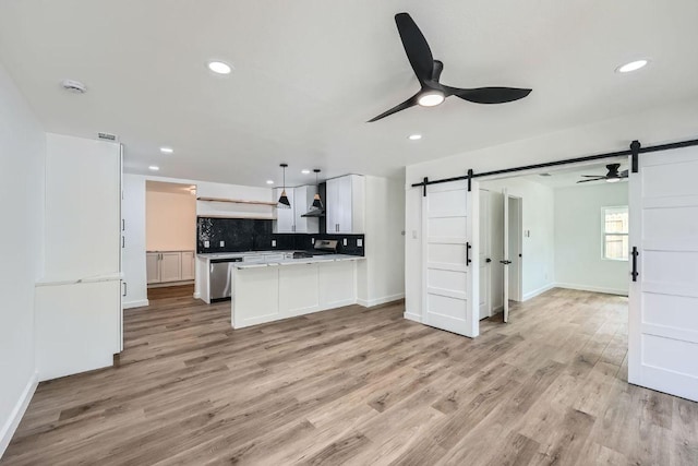 1601 N Redondo Dr, Austin, TX 78721 - kitchen with a barn door, a ceiling fan, appliances with stainless steel finishes, a peninsula, and recessed lighting