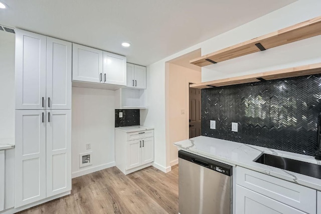 1601 N Redondo Dr, Austin, TX 78721 - kitchen with stainless steel dishwasher, light wood-style flooring, white cabinets, light stone countertops, and recessed lighting