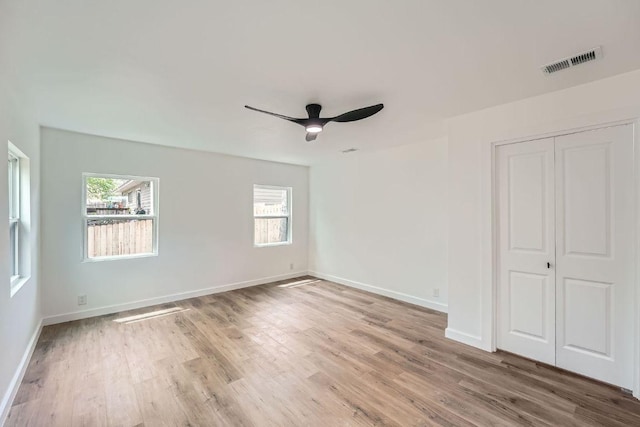 1601 N Redondo Dr, Austin, TX 78721 - unfurnished bedroom featuring light wood-type flooring, a closet, baseboards, and ceiling fan
