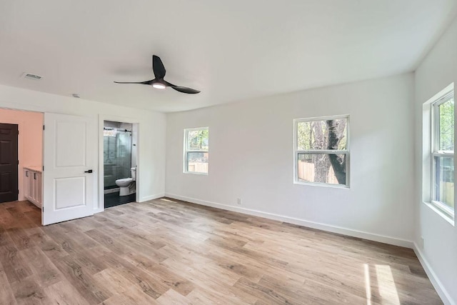 1601 N Redondo Dr, Austin, TX 78721 - unfurnished bedroom with multiple windows, light wood-type flooring, and baseboards