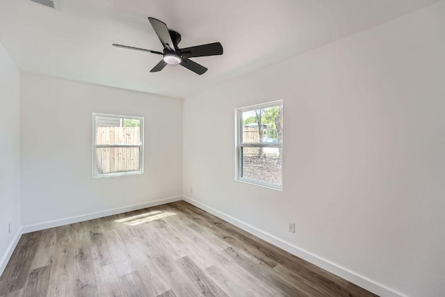 1601 N Redondo Dr, Austin, TX 78721 - spare room with wood finished floors, ceiling fan, and baseboards
