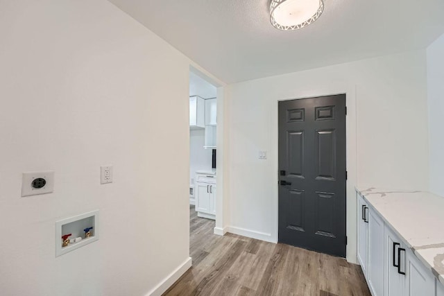 1601 N Redondo Dr, Austin, TX 78721 - laundry room with cabinet space, hookup for an electric dryer, washer hookup, and light wood-style floors