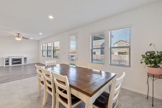 2308 Ringstaff Rd, Leander, TX 78641 - dining space with a ceiling fan, light tile patterned flooring, recessed lighting, a fireplace, and baseboards