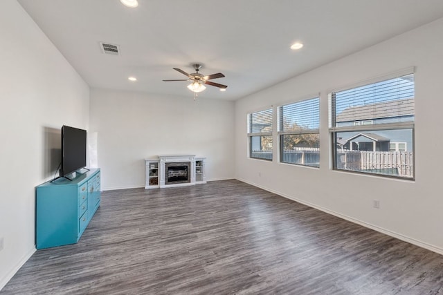 2308 Ringstaff Rd, Leander, TX 78641 - unfurnished living room with dark wood finished floors, ceiling fan, baseboards, a fireplace, and recessed lighting