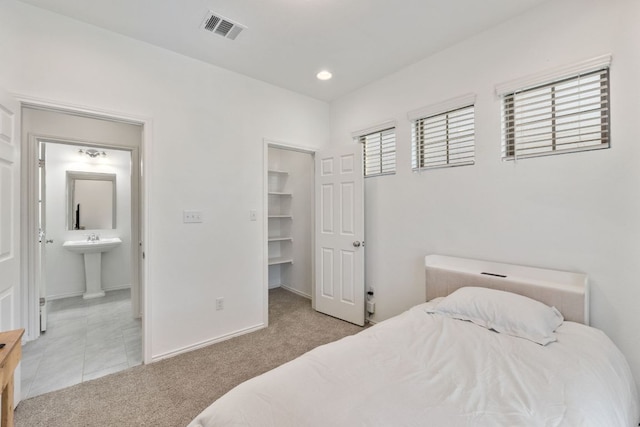 2308 Ringstaff Rd, Leander, TX 78641 - bedroom with carpet, a spacious closet, ensuite bath, baseboards, and a sink