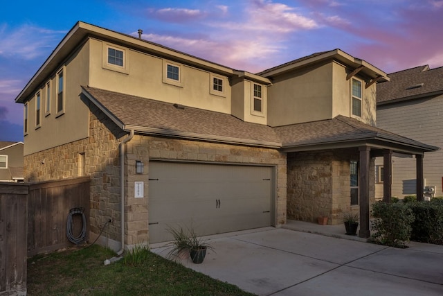 2308 Ringstaff Rd, Leander, TX 78641 - view of front of home with stone siding, a garage, stucco siding, and concrete driveway