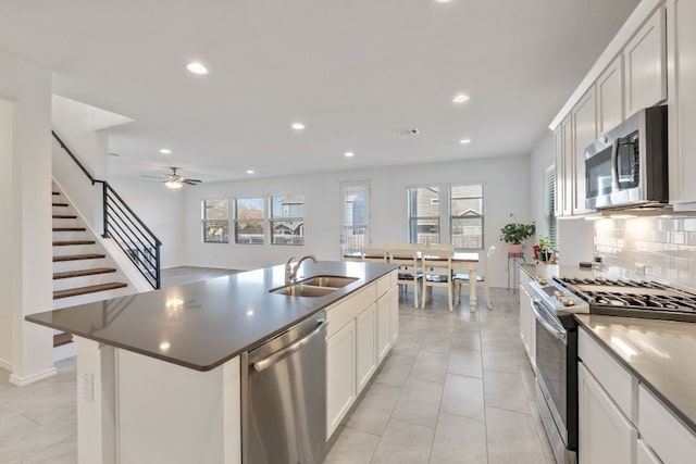 2308 Ringstaff Rd, Leander, TX 78641 - kitchen with stainless steel appliances, a sink, recessed lighting, decorative backsplash, and white cabinetry