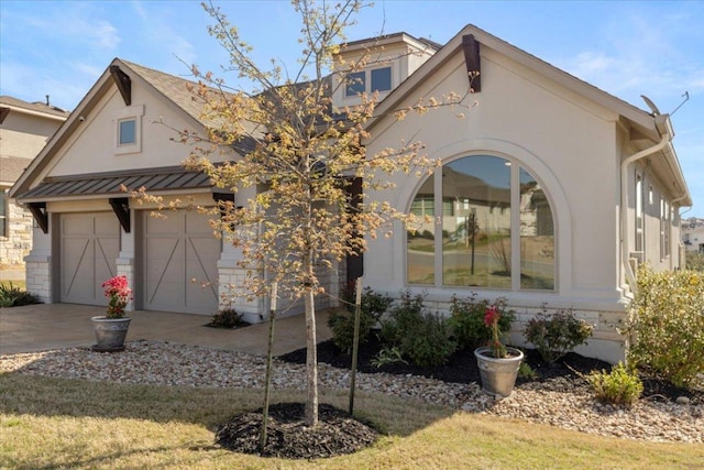 209 Gulfton St, Austin, TX 78738 - view of front of home featuring stucco siding, concrete driveway, and a garage