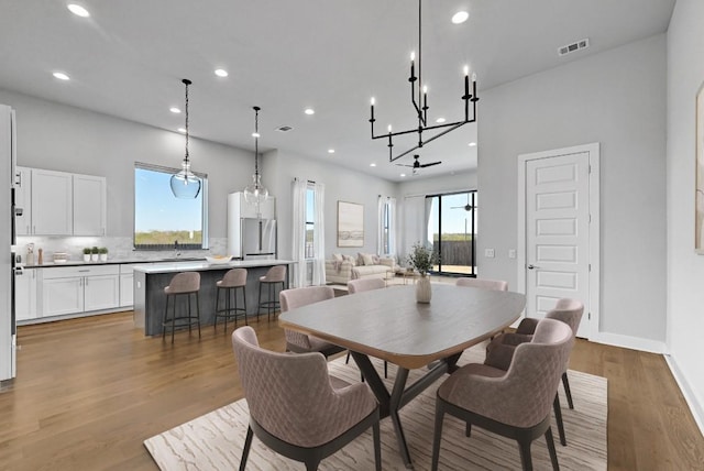 7200 Cordoba Dr, Austin, TX 78724 - dining space featuring recessed lighting, light wood-style flooring, a chandelier, and baseboards