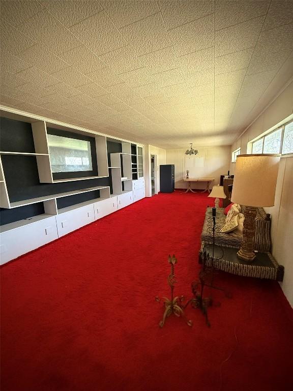 interior space featuring carpet flooring and a textured ceiling