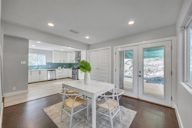 3510 Oak Springs Dr, Austin, TX 78721 - dining room with french doors, light wood-style floors, and recessed lighting
