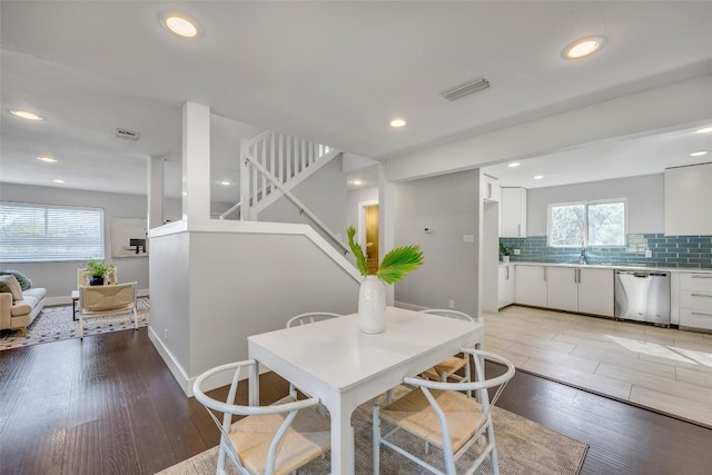 3510 Oak Springs Dr, Austin, TX 78721 - dining room featuring light wood-style flooring, recessed lighting, and stairway