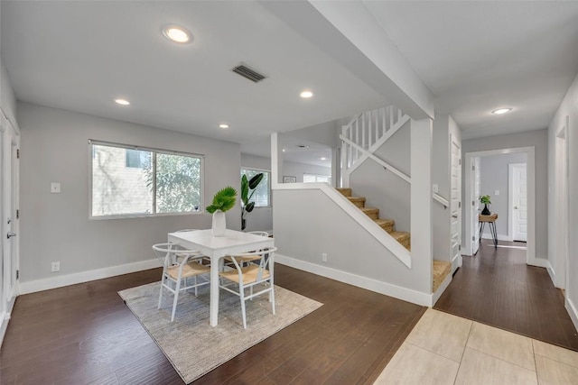 3510 Oak Springs Dr, Austin, TX 78721 - dining space with stairs, wood finished floors, and recessed lighting