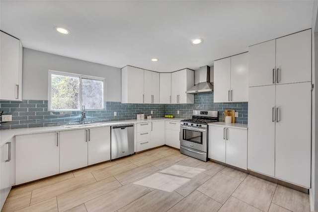 3510 Oak Springs Dr, Austin, TX 78721 - kitchen with stainless steel appliances, wall chimney range hood, light countertops, tasteful backsplash, and recessed lighting