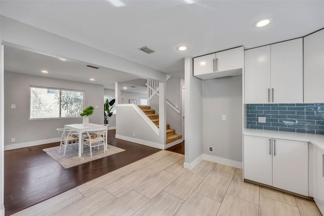 3510 Oak Springs Dr, Austin, TX 78721 - dining area with stairs, light wood-style flooring, and recessed lighting