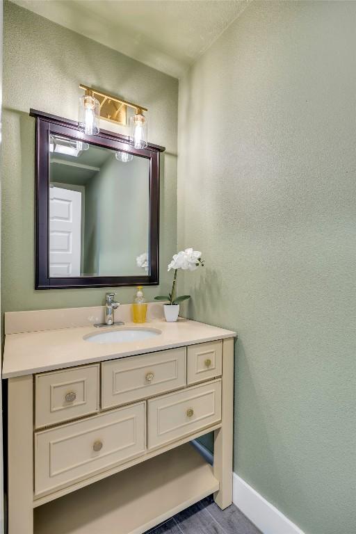 3510 Oak Springs Dr, Austin, TX 78721 - bathroom featuring vanity and a textured wall