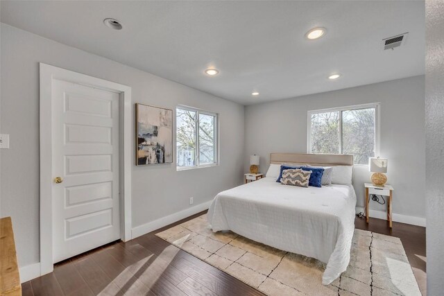 3510 Oak Springs Dr, Austin, TX 78721 - bedroom featuring multiple windows, wood finished floors, and recessed lighting