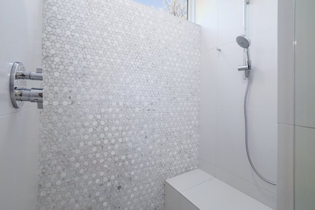 full bath featuring a tile shower